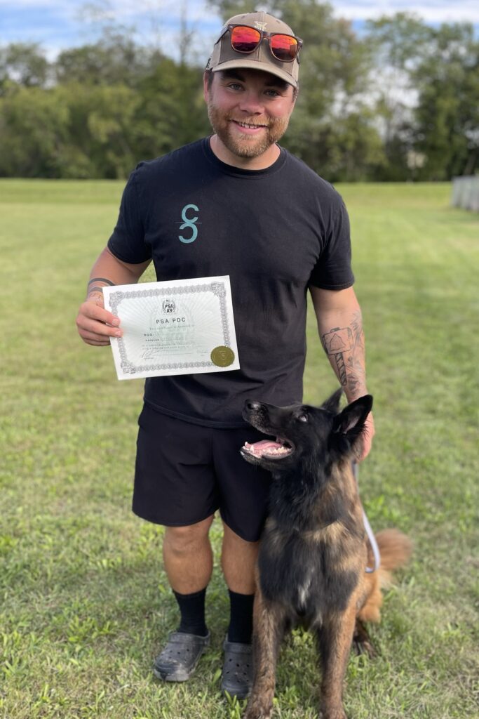 Trainer Lucas from The Cultured Canine standing with his dog